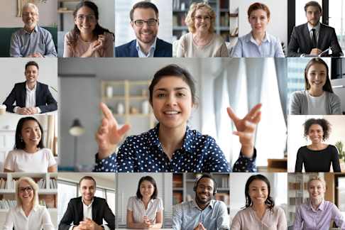 A collage of diverse professionals engaging in video calls, showcasing various smiling individuals in business attire. The setting appears to be professional, with each person either in an office or a well-lit room, suggesting a focus on teamwork and virtual communication. The central image features a woman animatedly speaking, surrounded by smaller images of others listening, promoting a sense of collaboration and inclusivity.
